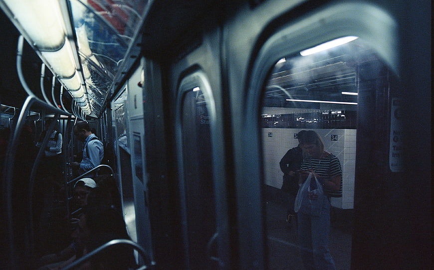 Candid Film Photo of Commuters in a Dimly Lit Subway Car