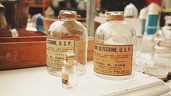 Vintage Apothecary Glycerine Bottles on White Counter