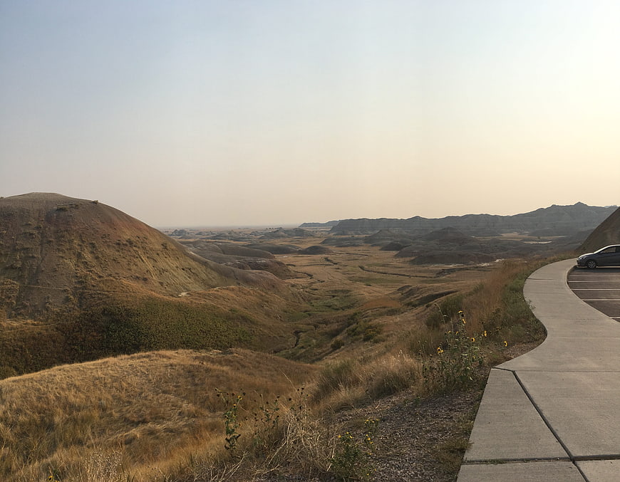 Scenic Badlands Vista with Winding Road and Dry Grass