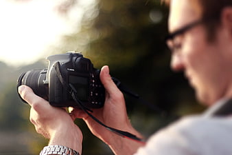 Man Holding DSLR Camera Outdoors