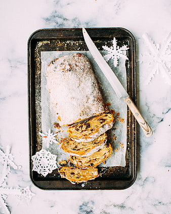 Sliced raisin bread loaf on baking sheet with snowflakes