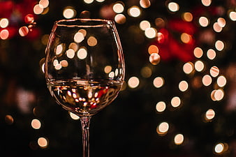 Wine glass with festive bokeh lights background