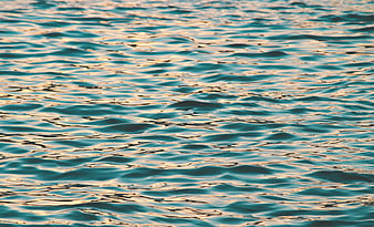 Golden Hour Reflections on Rippling Ocean Water Surface