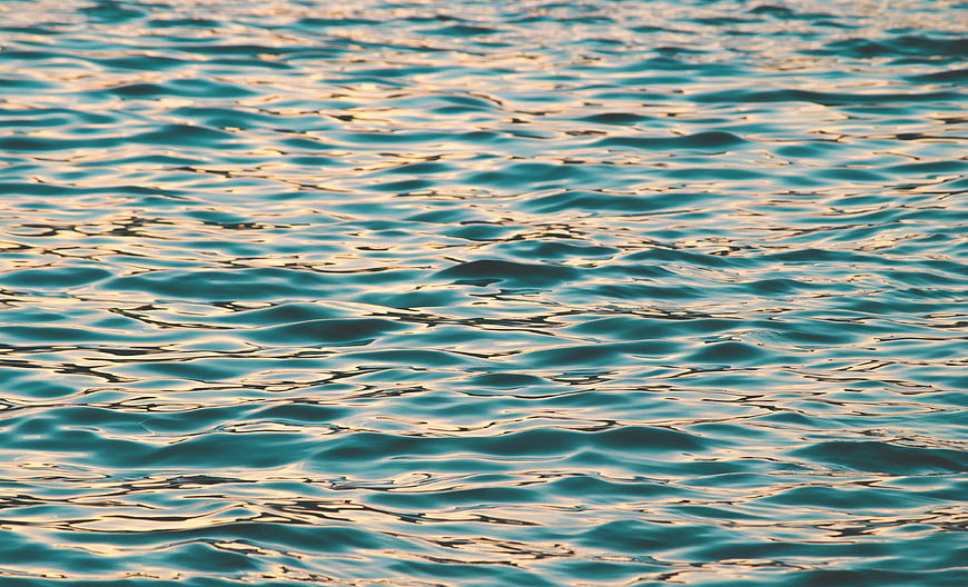 Golden Hour Reflections on Rippling Ocean Water Surface