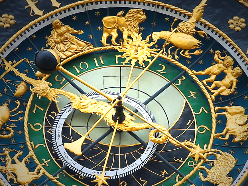 Close-Up of Golden Astronomical Clock Face with Zodiac Signs