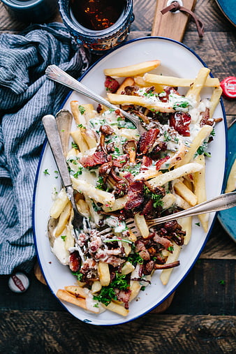 Overhead view of loaded truffle fries with bacon and mushrooms