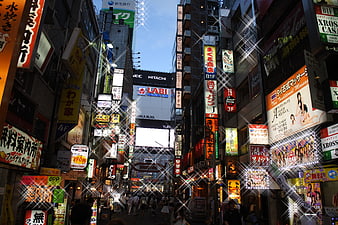 Bustling Japanese Street with Neon Signs and Crowds