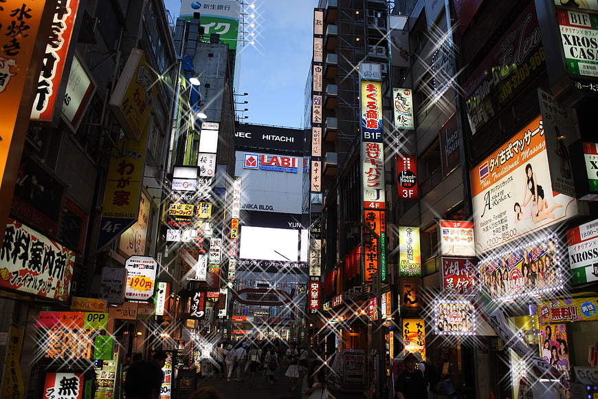 Bustling Japanese Street with Neon Signs and Crowds