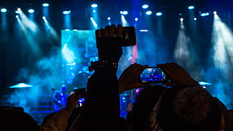 Concert audience recording live music performance with smartphones