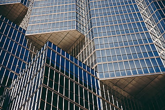 Modern glass skyscraper facade with geometric patterns