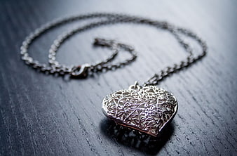 Silver Heart Locket Necklace on Dark Wood