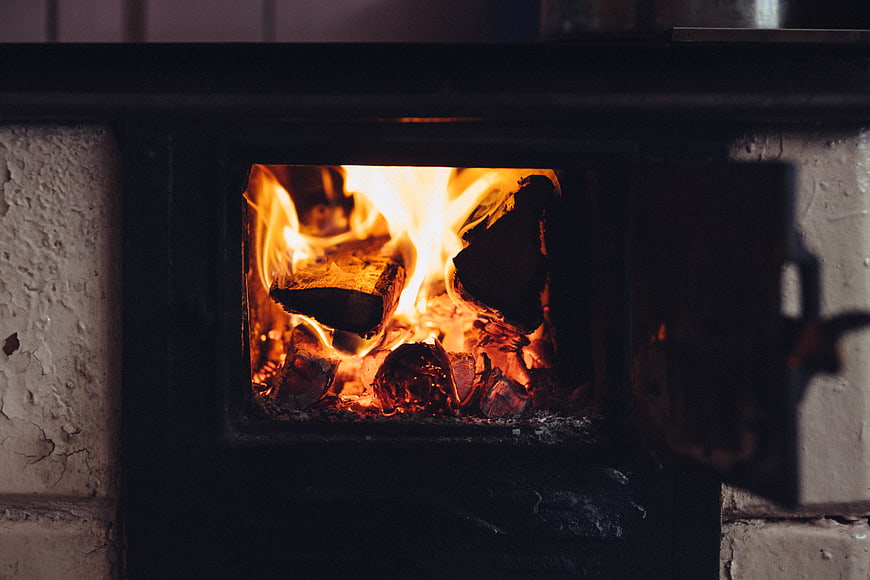 Close-up of burning firewood in a rustic wood stove