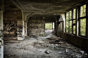 Abandoned building interior with graffiti and debris
