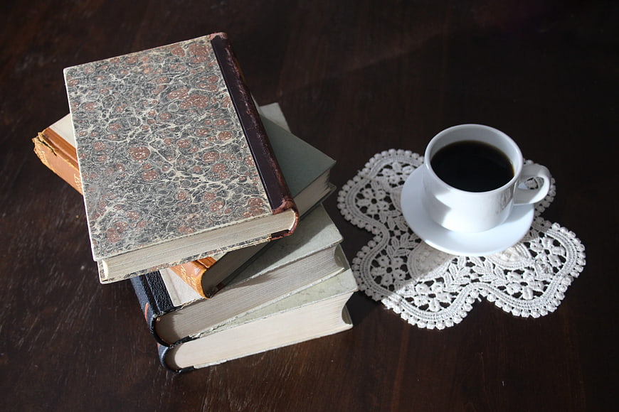 Vintage Books and Coffee on Dark Wooden Table
