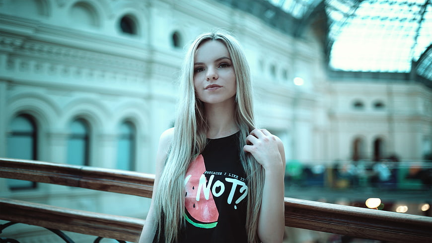 Young Blonde Woman in Graphic Tee on Balcony