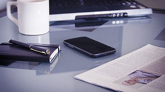 Modern Office Desk Setup With Laptop, Smartphone, Notebook, Pen, And Coffee
