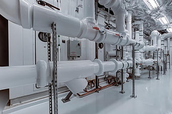 White industrial pipes in a modern utility room