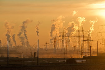 Industrial Power Plant Smokestacks at Golden Sunset