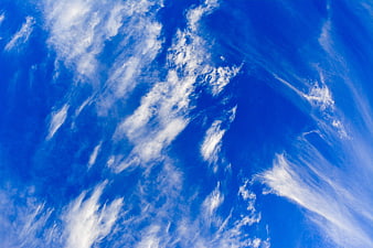 Vibrant blue sky with wispy white cirrus clouds