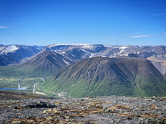 Scenic Mountain Landscape with Snow-Capped Peaks and Green Valley