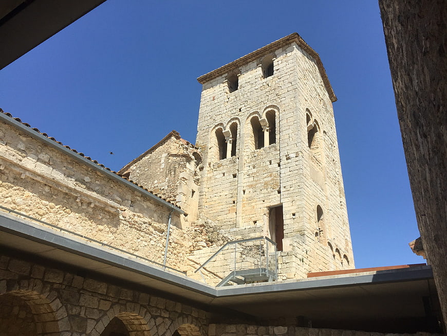 Low angle view of ancient Romanesque stone church tower