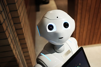 Close-up of white humanoid robot with glowing blue eyes