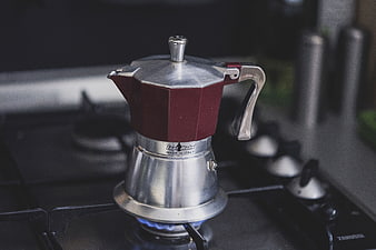 Red Moka Pot Brewing Coffee on Gas Stove