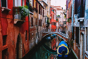 Colorful Venice Canal with Arched Bridge and Moored Boats