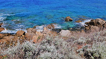 Aerial View of Rocky Coastline with Turquoise Ocean Water