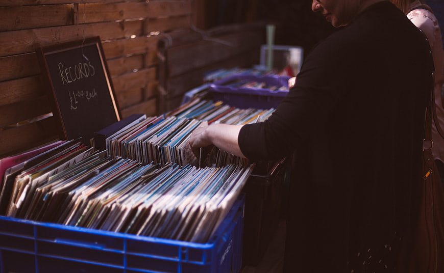 Woman Browsing Vinyl Records At Outdoor Market Stall