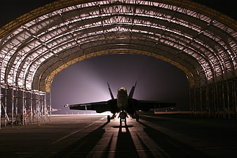 Fighter Jet Silhouette in Hangar at Night
