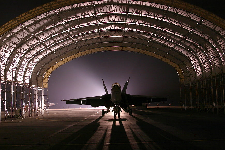 Fighter Jet Silhouette in Hangar at Night