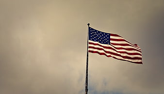 American Flag Waving Against Overcast Sky