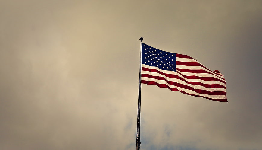 American Flag Waving Against Overcast Sky