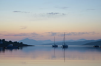Sailboats Anchored in Calm Harbor at Sunset