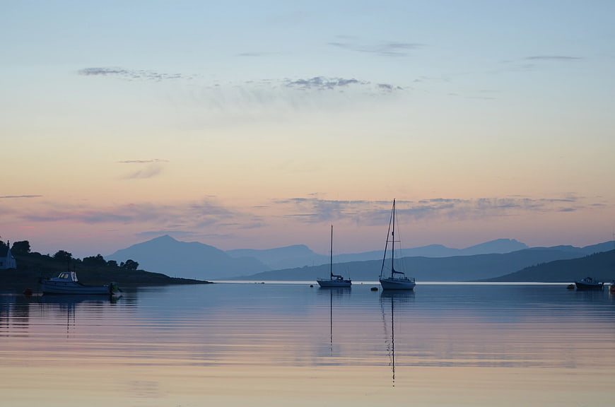 Sailboats Anchored in Calm Harbor at Sunset