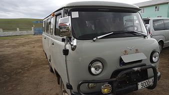Vintage gray UAZ-452 van parked on dirt road in Mongolia