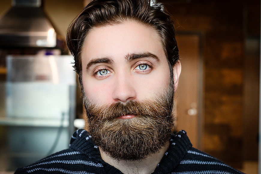 Close-up portrait of handsome bearded man with blue eyes