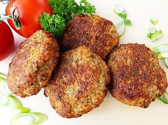 Fried meatballs with fresh tomatoes and green onions