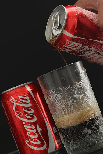 Coca-Cola Can Pouring Into Iced Glass