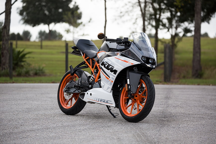 White and Orange KTM RC Electric Motorcycle on Asphalt