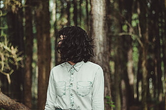 Woman with Dark Hair in Denim Shirt in Forest