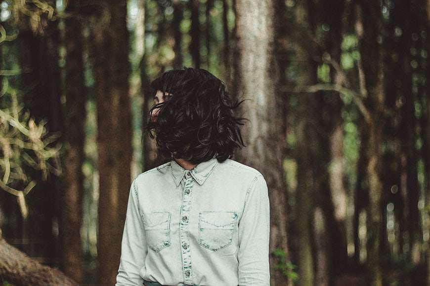 Woman with Dark Hair in Denim Shirt in Forest