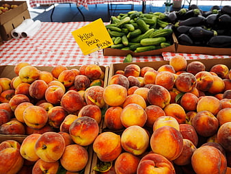 Fresh Yellow Peaches at Farmers Market with Price Sign