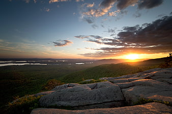 Sunset Over Rocky Mountain Ridge and Forested Valley