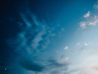 Dramatic Blue Sky with Wispy Clouds and Crescent Moon