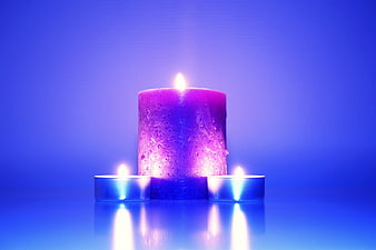 Purple Candle with Tea Lights on Blue Background