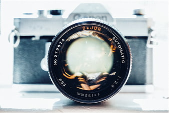 Close-up of vintage DeJUR camera lens with blurred background