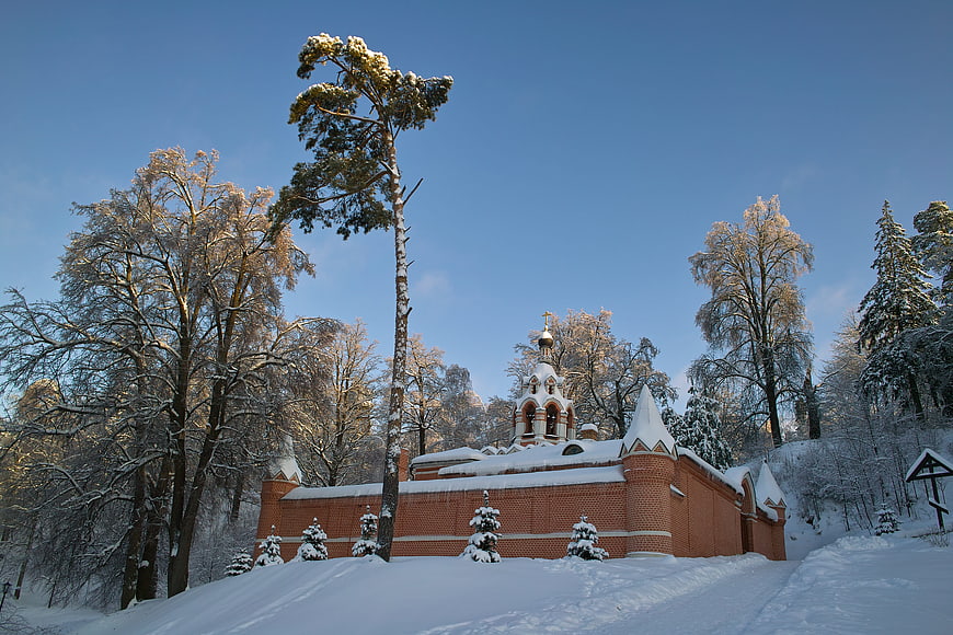 Snow-covered Orthodox Church in Winter Forest