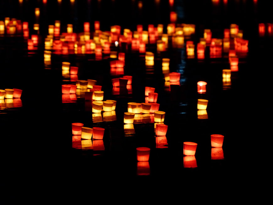 Floating Candles on Dark Water at Night